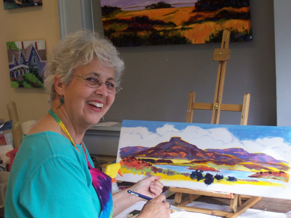 Louise Minks in her home working on a painting
